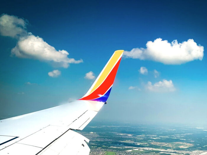 Southwest Airlines marketing mix 4Ps 4P, product, price, promotion, place, business analysis, airplane wing over Texas