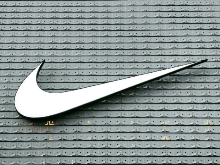 Nike company structure, organizational hierarchy, corporate divisions, headquarters, departments, advantages, sporting goods business analysis, Swoosh sign