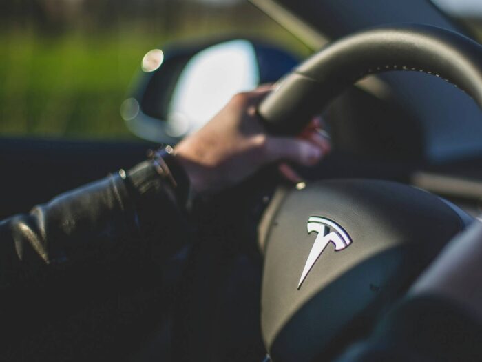 Tesla organizational structure, corporate departments, divisions, company hierarchy, organizational design, automotive energy business analysis, steering wheel